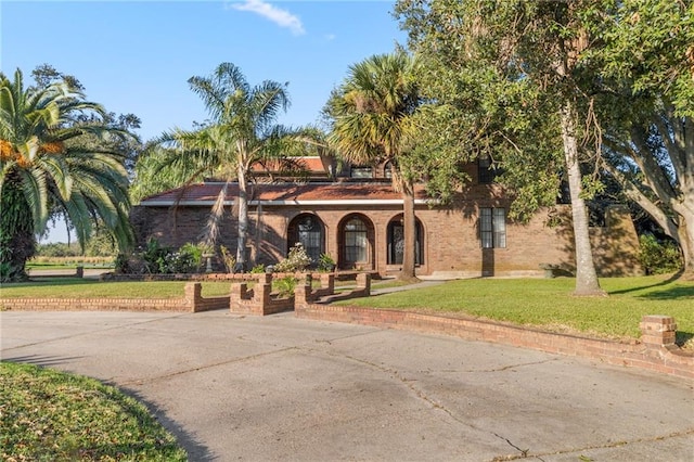 mediterranean / spanish-style home featuring a front lawn