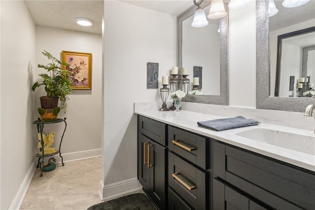 bathroom with vanity and a textured ceiling