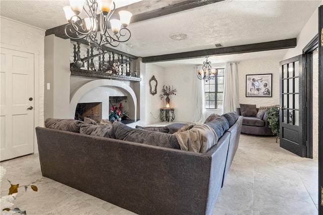 living room featuring a chandelier, a textured ceiling, and beam ceiling