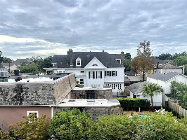 3000 St Charles Ave Unit 409, New Orleans, LA 70115 - rear view of house featuring a chimney and a residential view