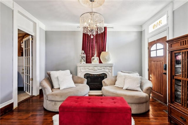 sitting room featuring dark hardwood / wood-style flooring and a notable chandelier