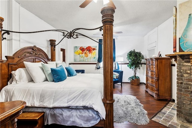 bedroom with a textured ceiling, dark hardwood / wood-style floors, and ceiling fan