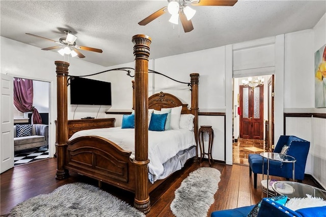 bedroom with dark hardwood / wood-style flooring, a textured ceiling, ceiling fan, and ensuite bathroom