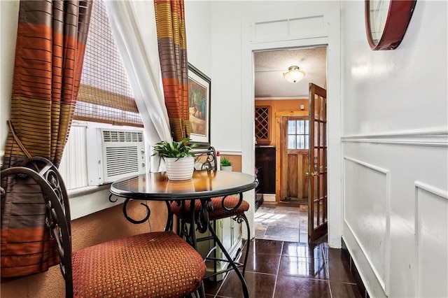 dining area featuring cooling unit and ornamental molding