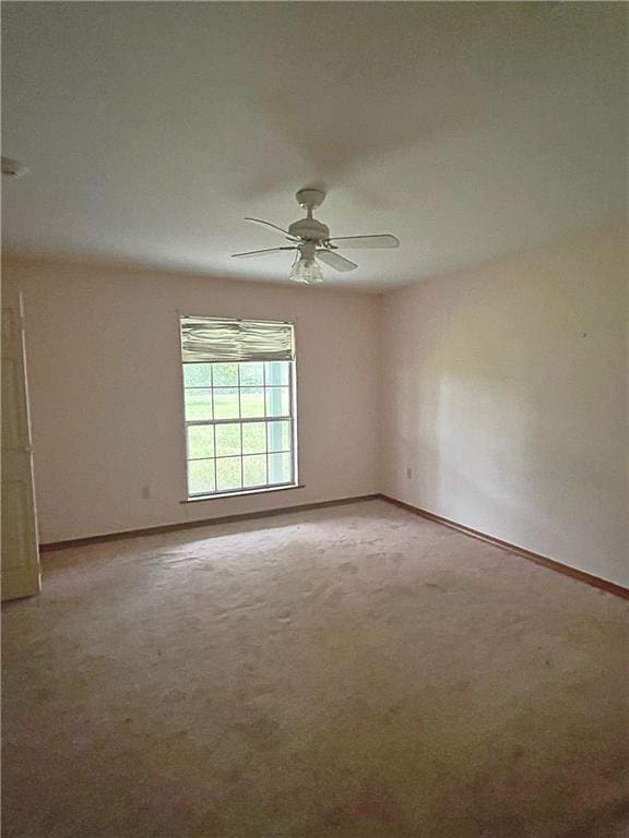 unfurnished room featuring carpet and ceiling fan