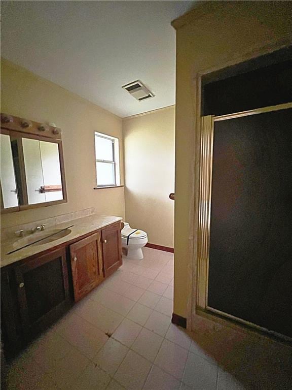 bathroom featuring vanity, toilet, and walk in shower