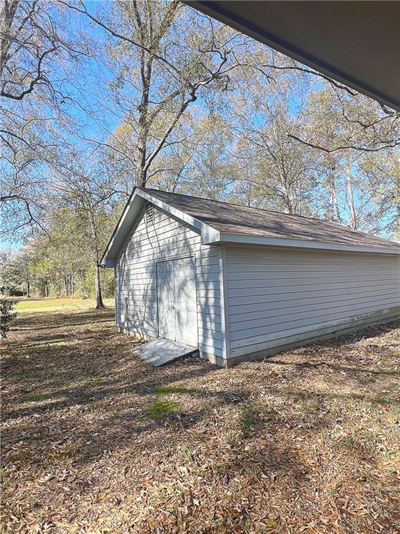 view of home's exterior featuring an outbuilding