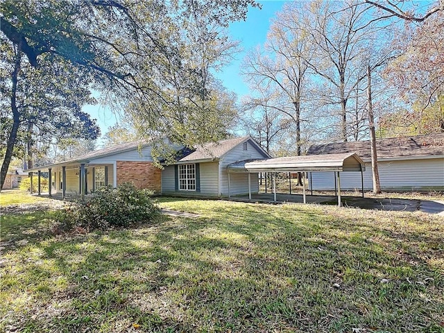 view of front of property with a front yard and a carport