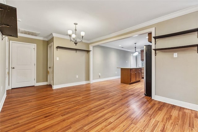 unfurnished living room featuring ornamental molding, light hardwood / wood-style floors, and a notable chandelier