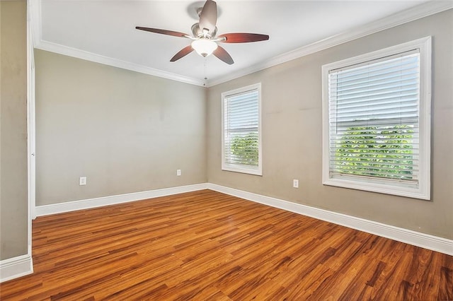 unfurnished room with hardwood / wood-style flooring, a healthy amount of sunlight, and crown molding