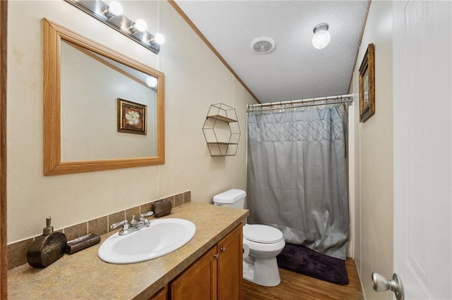 bathroom featuring walk in shower, wood-type flooring, a textured ceiling, toilet, and vanity