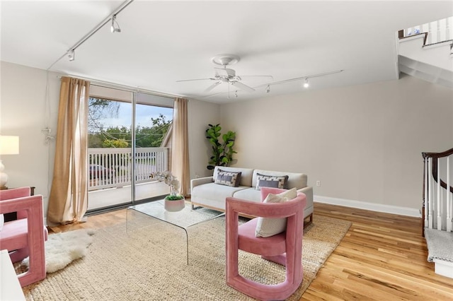 living room featuring hardwood / wood-style floors, ceiling fan, and rail lighting