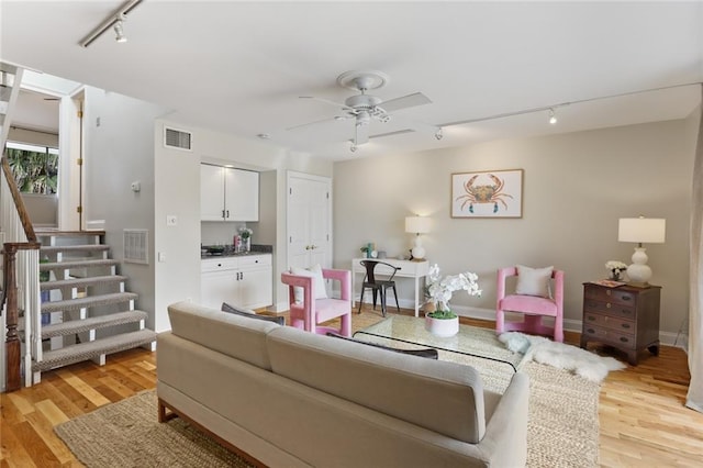 living room featuring ceiling fan, track lighting, and light hardwood / wood-style floors