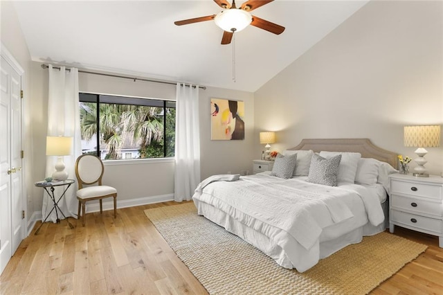 bedroom with light hardwood / wood-style flooring, ceiling fan, and vaulted ceiling