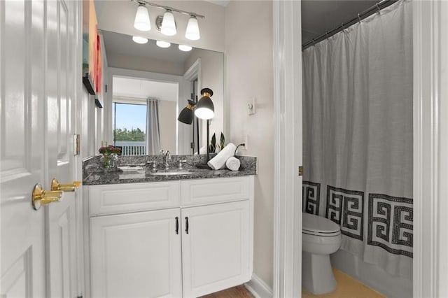 bathroom featuring vanity, toilet, and a shower with shower curtain