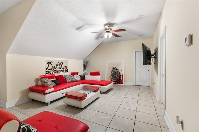 living room with vaulted ceiling, light tile patterned floors, ceiling fan, and a textured ceiling