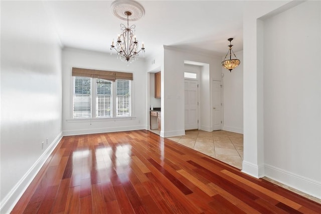 interior space with light hardwood / wood-style floors and a notable chandelier