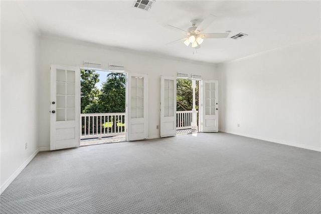 carpeted empty room with ceiling fan and crown molding