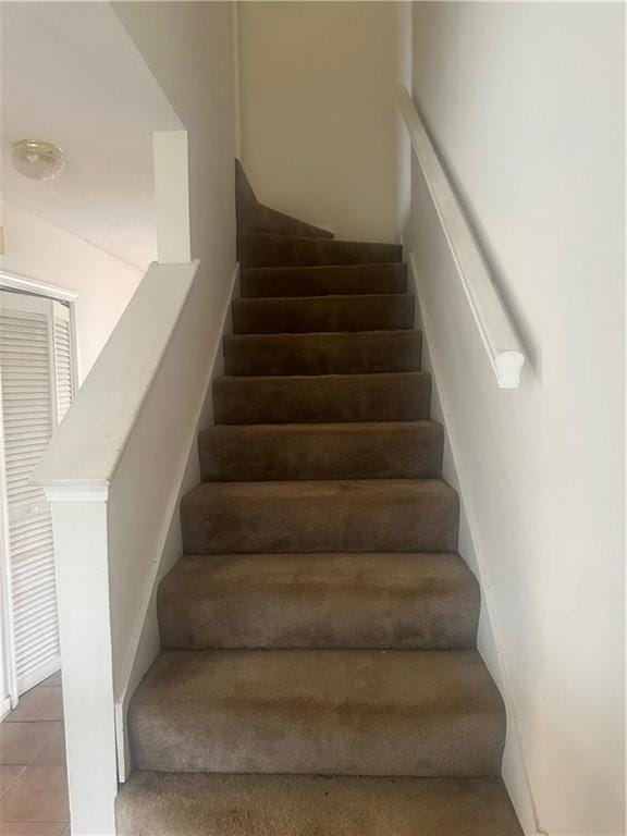 stairs with tile patterned floors