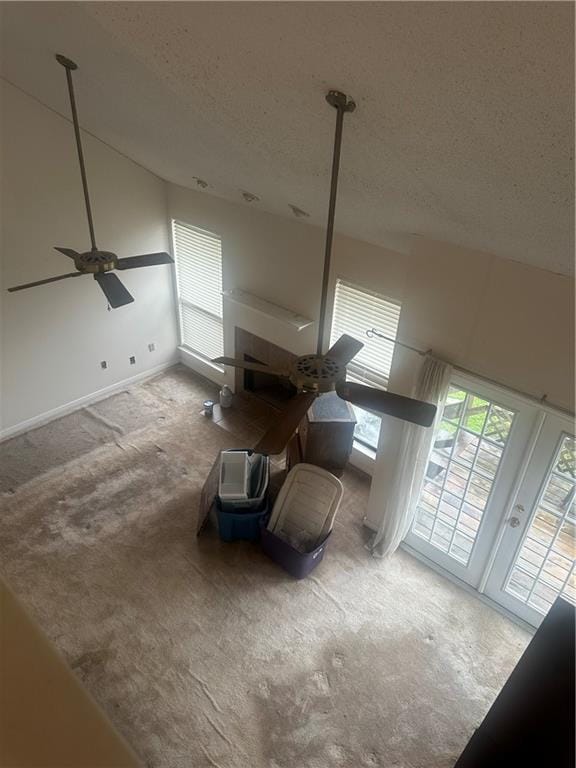 bonus room with high vaulted ceiling, a textured ceiling, carpet flooring, and ceiling fan