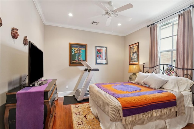 bedroom featuring dark wood-type flooring, ceiling fan, and ornamental molding