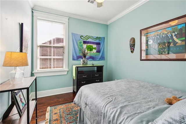 bedroom featuring ornamental molding, dark wood-type flooring, and ceiling fan