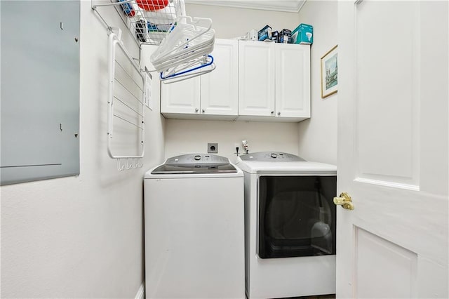 clothes washing area featuring electric panel, cabinets, separate washer and dryer, and crown molding