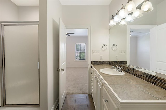 bathroom with tile patterned flooring, vanity, and a shower with door