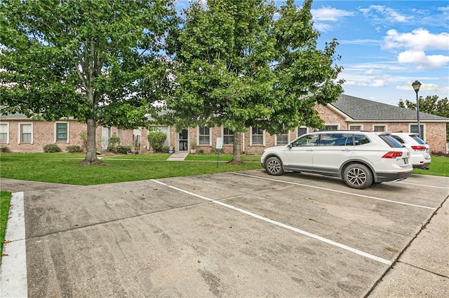 view of vehicle parking with a yard