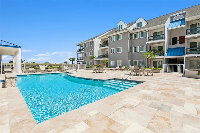 view of swimming pool with a patio area