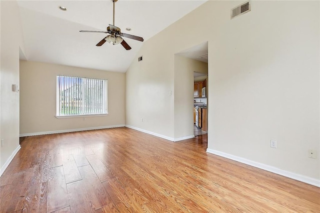 empty room featuring light hardwood / wood-style flooring, lofted ceiling, and ceiling fan