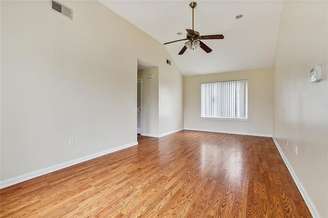 empty room with light wood-type flooring, vaulted ceiling, and ceiling fan