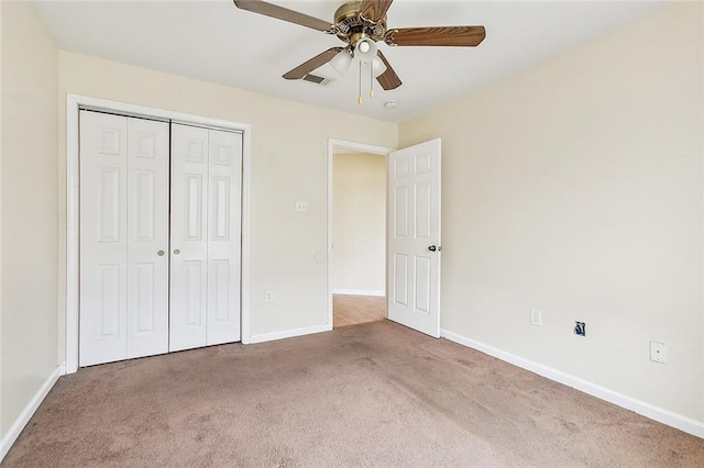 unfurnished bedroom with carpet floors, ceiling fan, and a closet