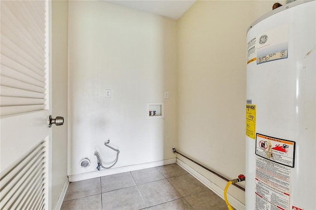 laundry area with hookup for a washing machine, gas water heater, and light tile patterned floors