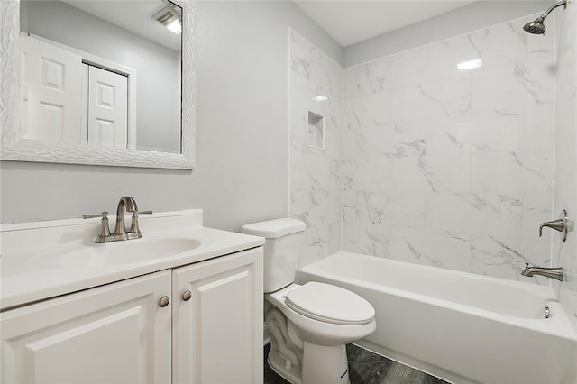 full bathroom with wood-type flooring, vanity, toilet, and tiled shower / bath