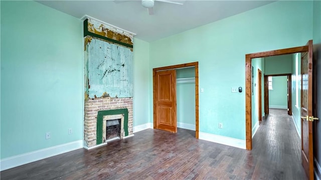 2610 Peniston St, New Orleans, LA 70115 - unfurnished living room featuring dark hardwood / wood-style flooring, ceiling fan, and a fireplace