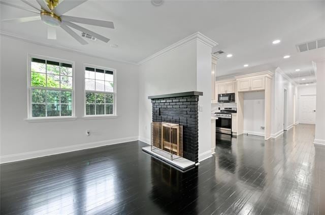 unfurnished living room featuring ceiling fan, crown molding, dark wood-type flooring, and a brick fireplace