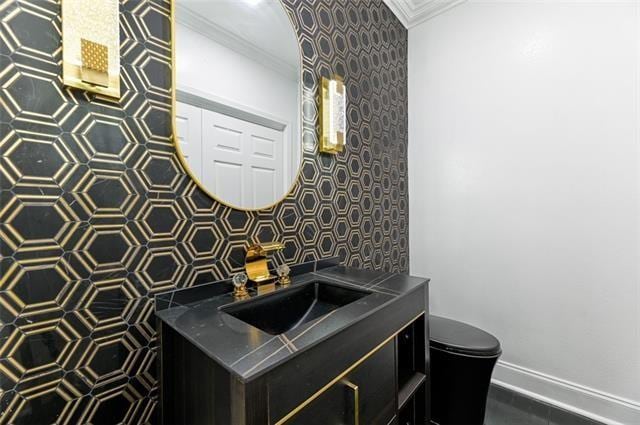 bathroom featuring vanity, toilet, and crown molding