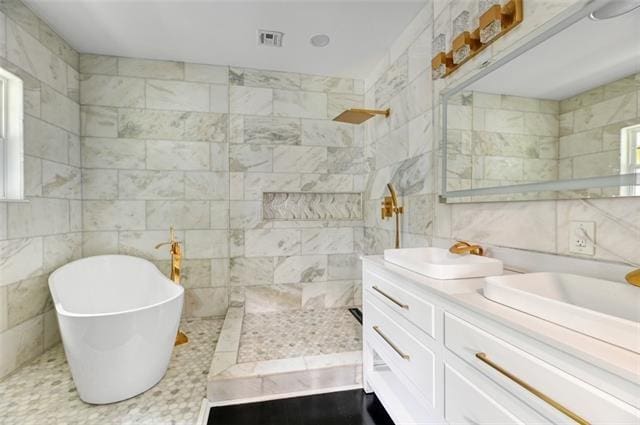 bathroom with vanity, tile walls, and plus walk in shower