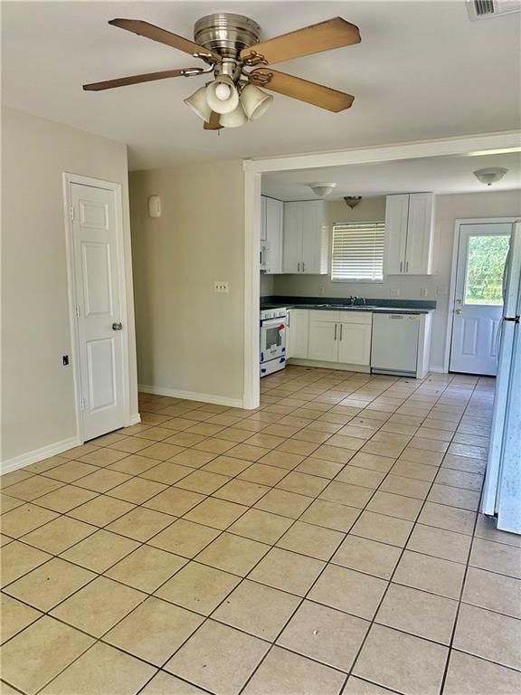 kitchen with sink, light tile patterned floors, ceiling fan, white cabinetry, and white appliances