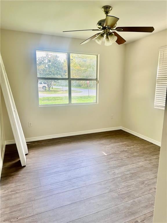 empty room featuring light hardwood / wood-style flooring and ceiling fan