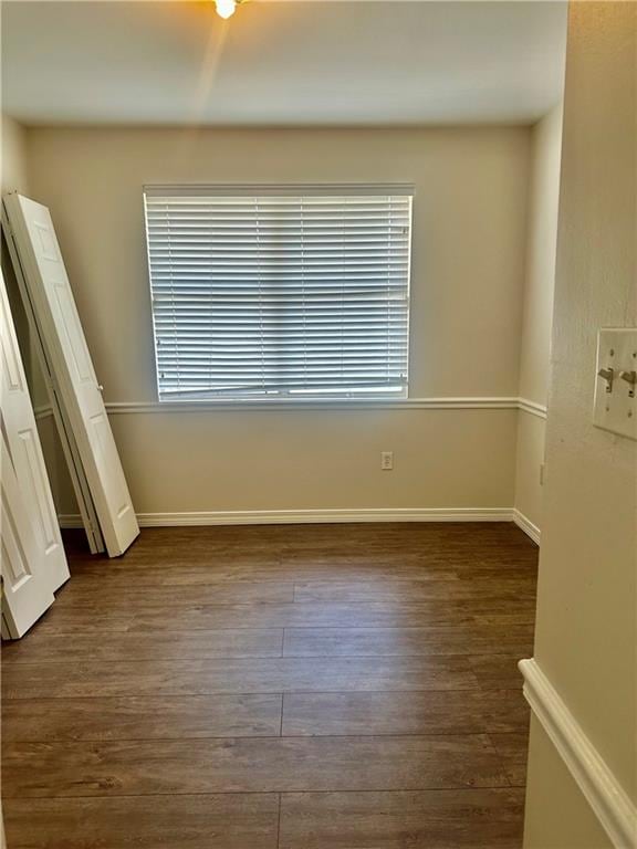 empty room featuring dark hardwood / wood-style flooring