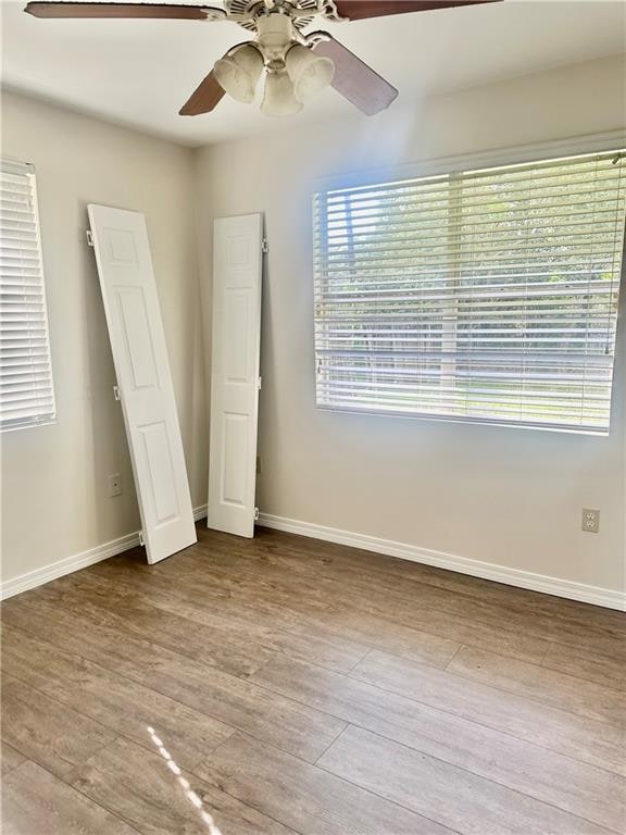 unfurnished bedroom with light hardwood / wood-style floors and ceiling fan