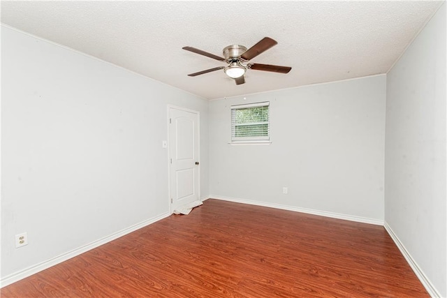 unfurnished room featuring ceiling fan, wood finished floors, baseboards, and a textured ceiling
