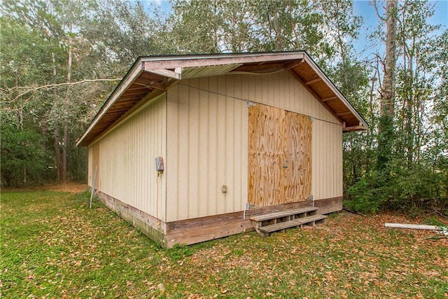 view of outbuilding featuring a lawn