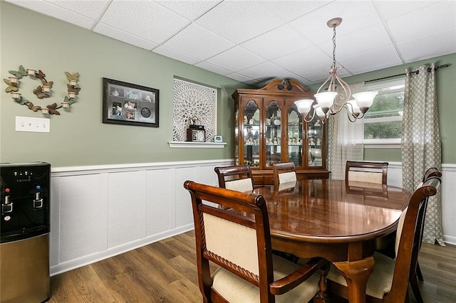 dining room featuring a paneled ceiling, dark hardwood / wood-style floors, and a chandelier