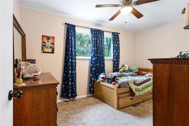 carpeted bedroom featuring ceiling fan and ornamental molding