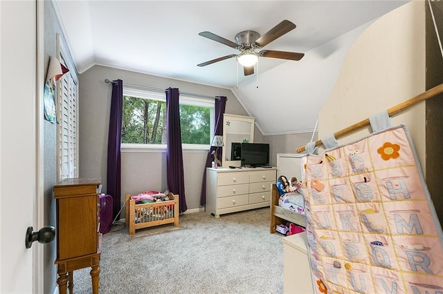 carpeted bedroom with ceiling fan and vaulted ceiling