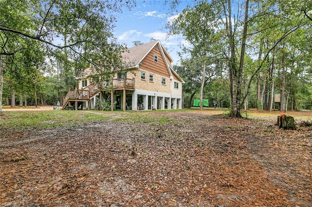 back of property featuring a wooden deck