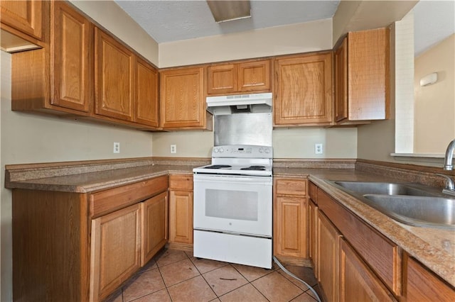 kitchen with light tile patterned flooring, white electric range, and sink